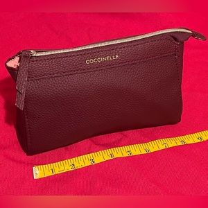 Coccinelle labeled cosmetics bag.